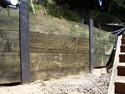 Wood bulkhead retaining wall with steel I-Beams